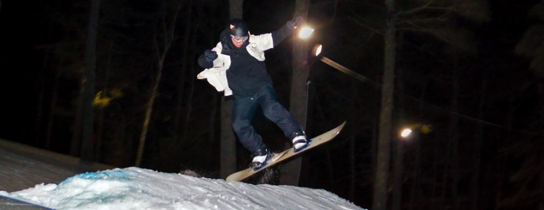 A student catches air while skiing